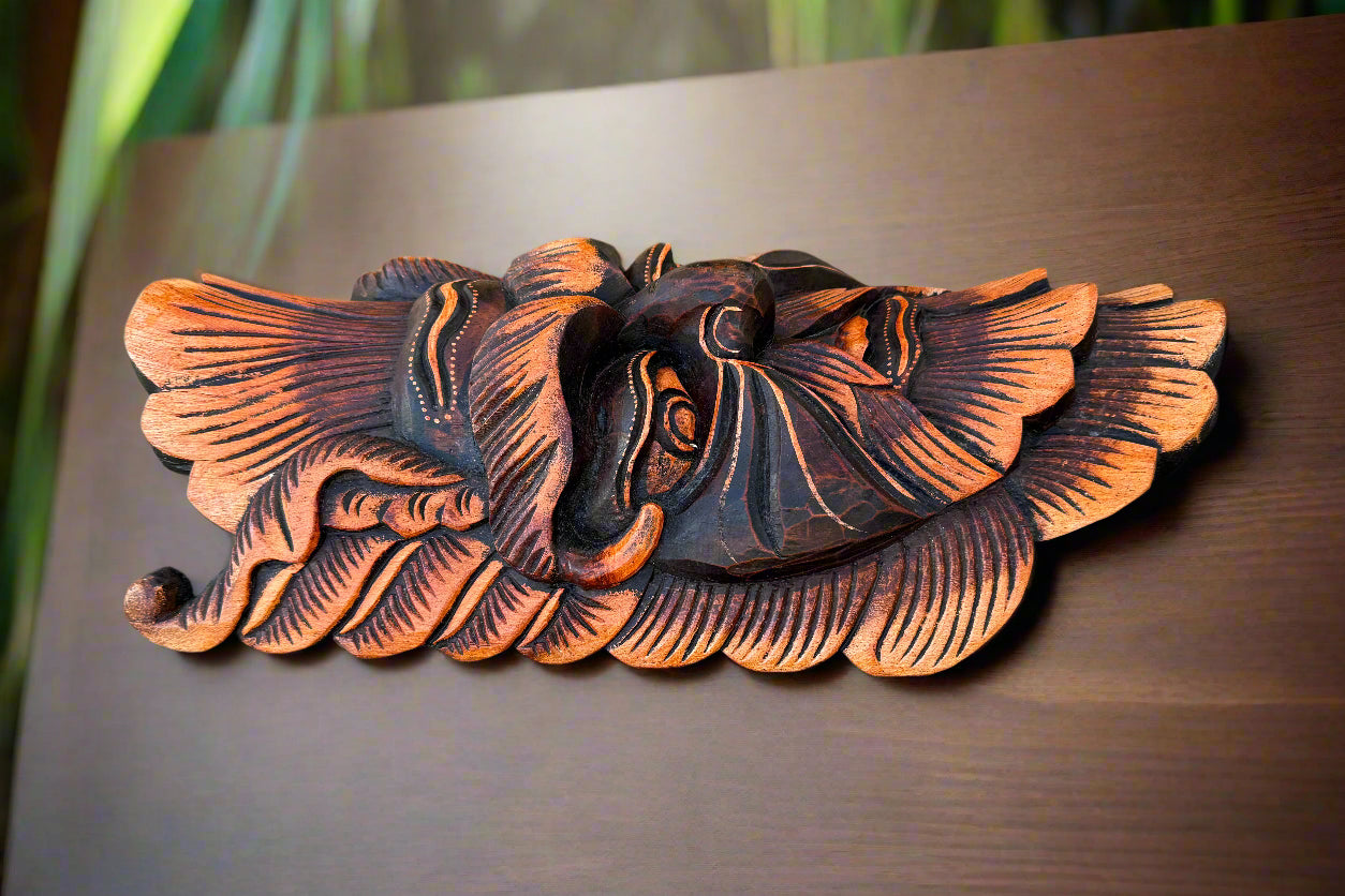 intricately carved wooden bird wall art with orange accents