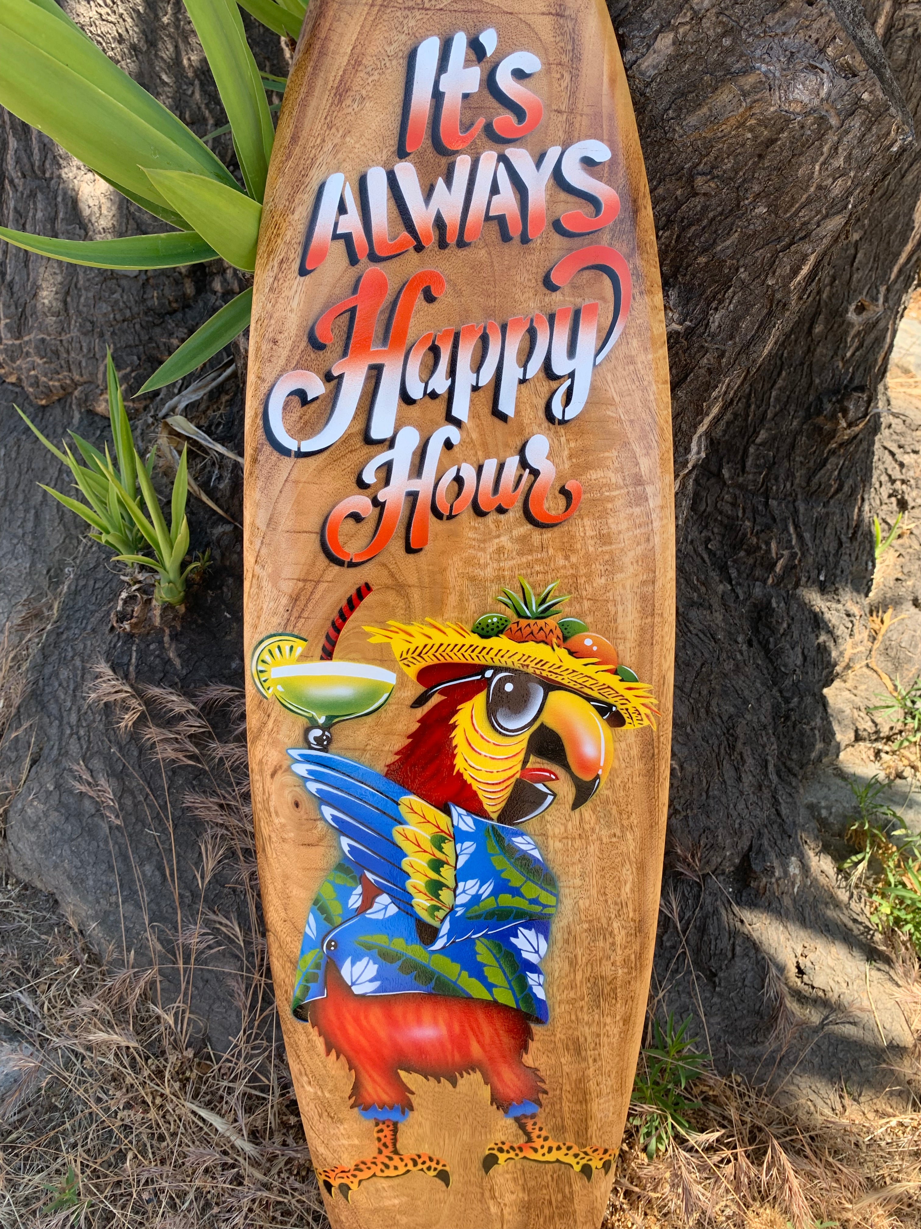 Colorful parrot wearing a hat on a wooden sign that reads It's Always Happy Hour with a tropical cocktail.