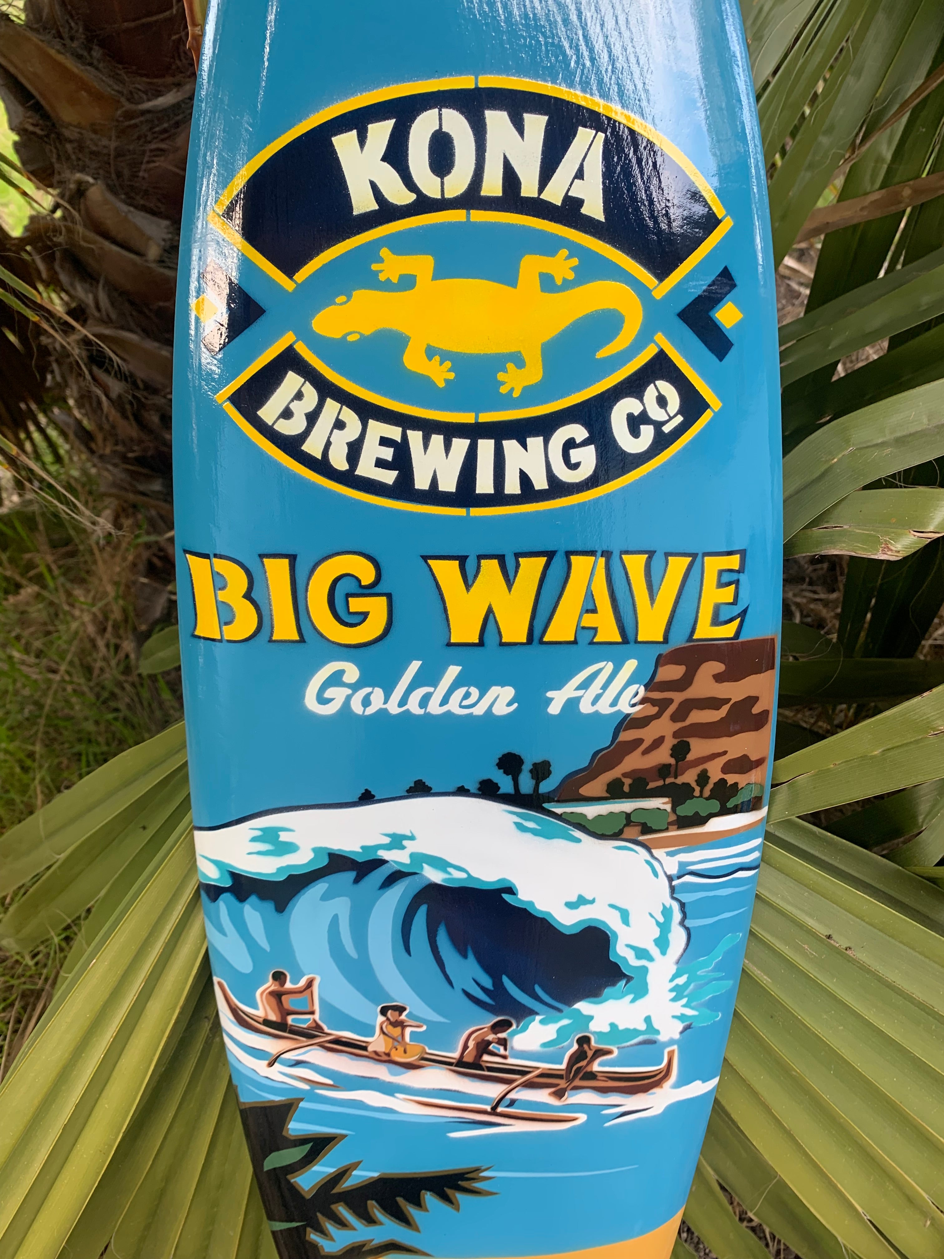 Kona Brewing Big Wave Golden Ale sign with surfers and a large ocean wave