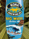Kona Brewing Big Wave Golden Ale sign with surfers and a large ocean wave