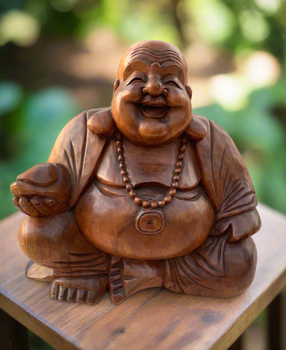 Smiling Laughing Buddha wooden statue with beaded necklace outdoors