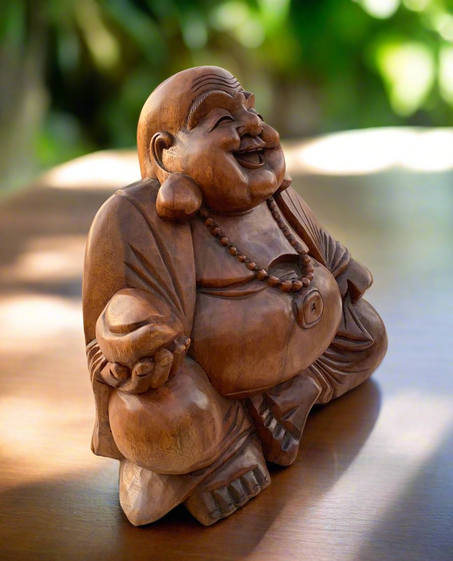 Wooden laughing Buddha statue with beaded necklace, smiling figure.