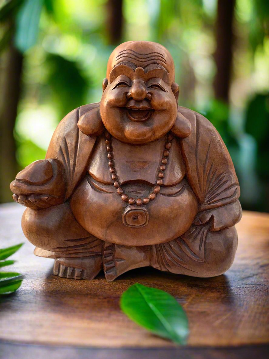 Smiling Laughing Buddha wooden statue with a beaded necklace on a wooden surface