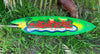 Bright green surfboard with Margarita Ville tropical beach scene on grass