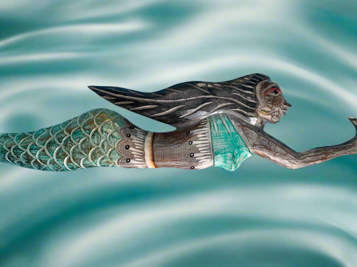 Carved wooden mermaid sculpture with teal top and green-scaled tail