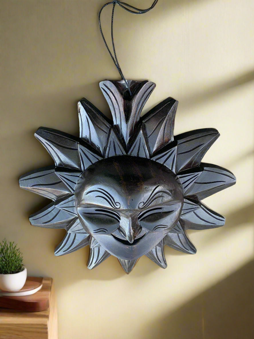 Metal sun-shaped wall decor with a smiling face and decorative rays