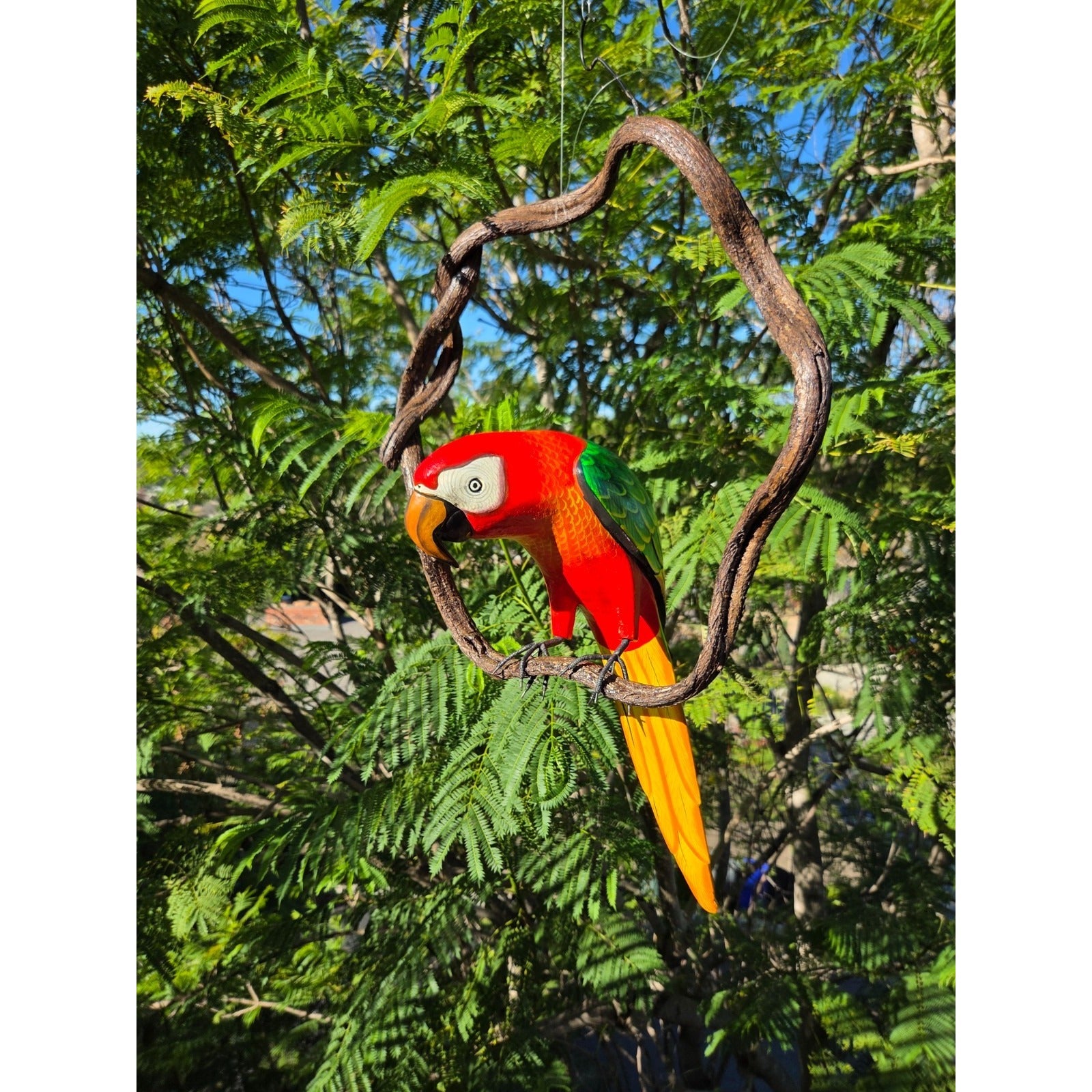 Colorful parrot perched on a branch with green foliage in the background