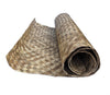 Rolled natural woven straw mat on white background