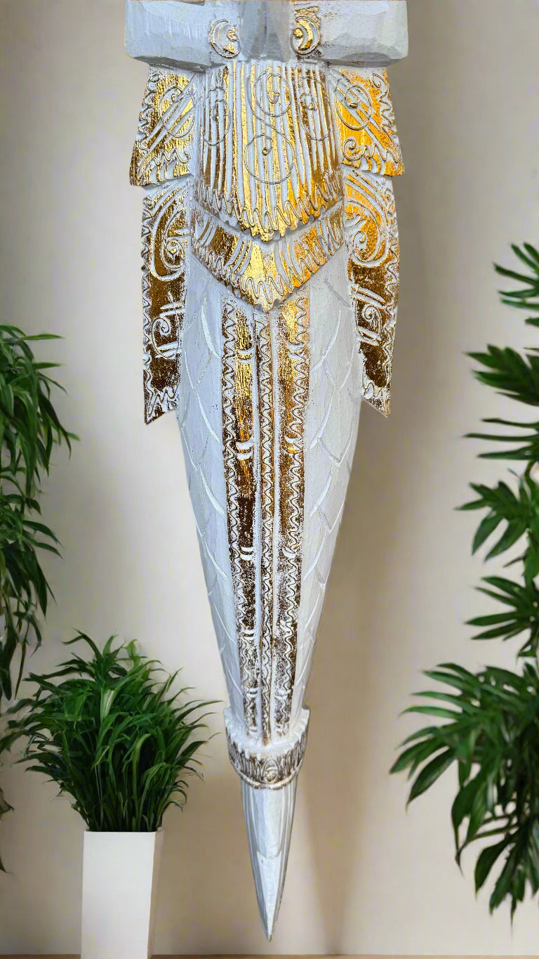 Ornate white and gold carved dagger-shaped statue with intricate patterns.