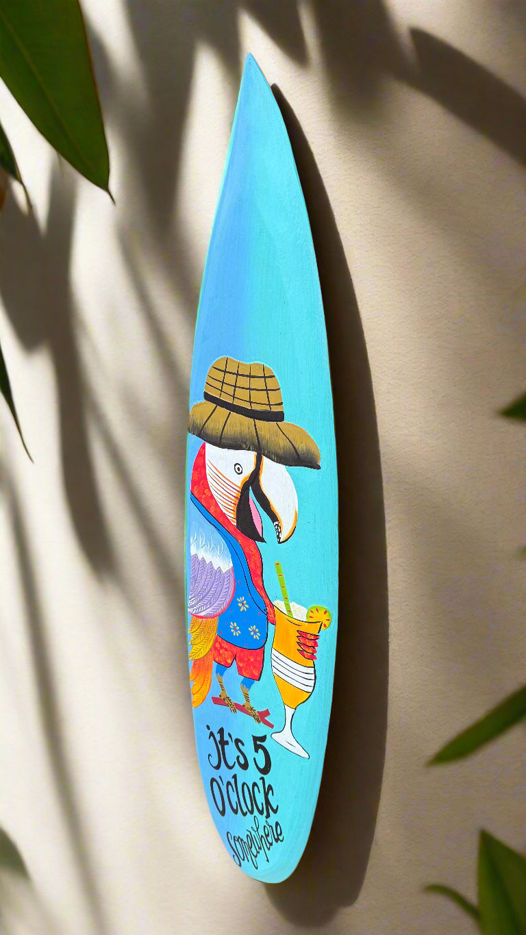 Colorful parrot on turquoise surfboard wall art with hat and cocktail