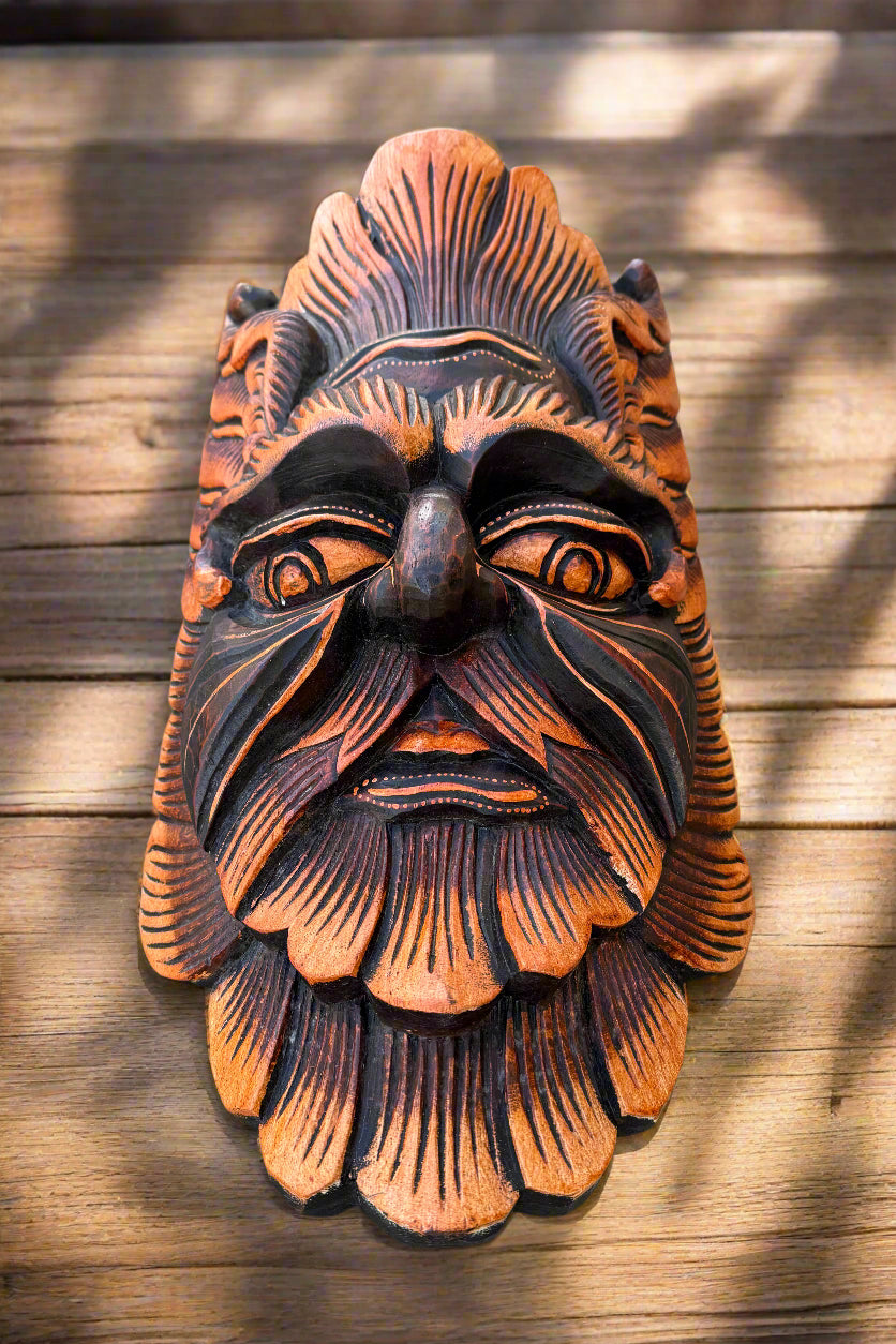 Polynesian tiki wooden mask with orange and black carved details