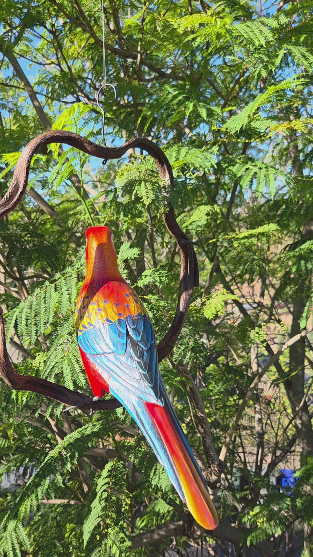 Wooden Macaw Statue on wooden perch.
