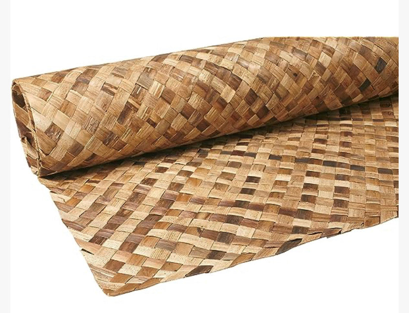 Close-up of a rolled bamboo woven mat with a checker-like pattern in natural brown tones