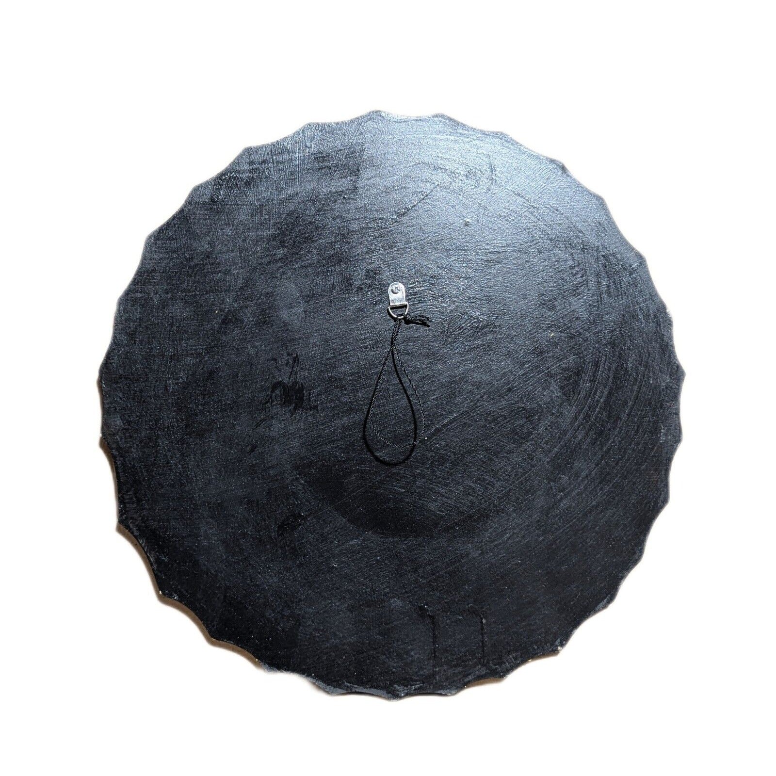 round black slate disc with a small metal hook and loop at the center