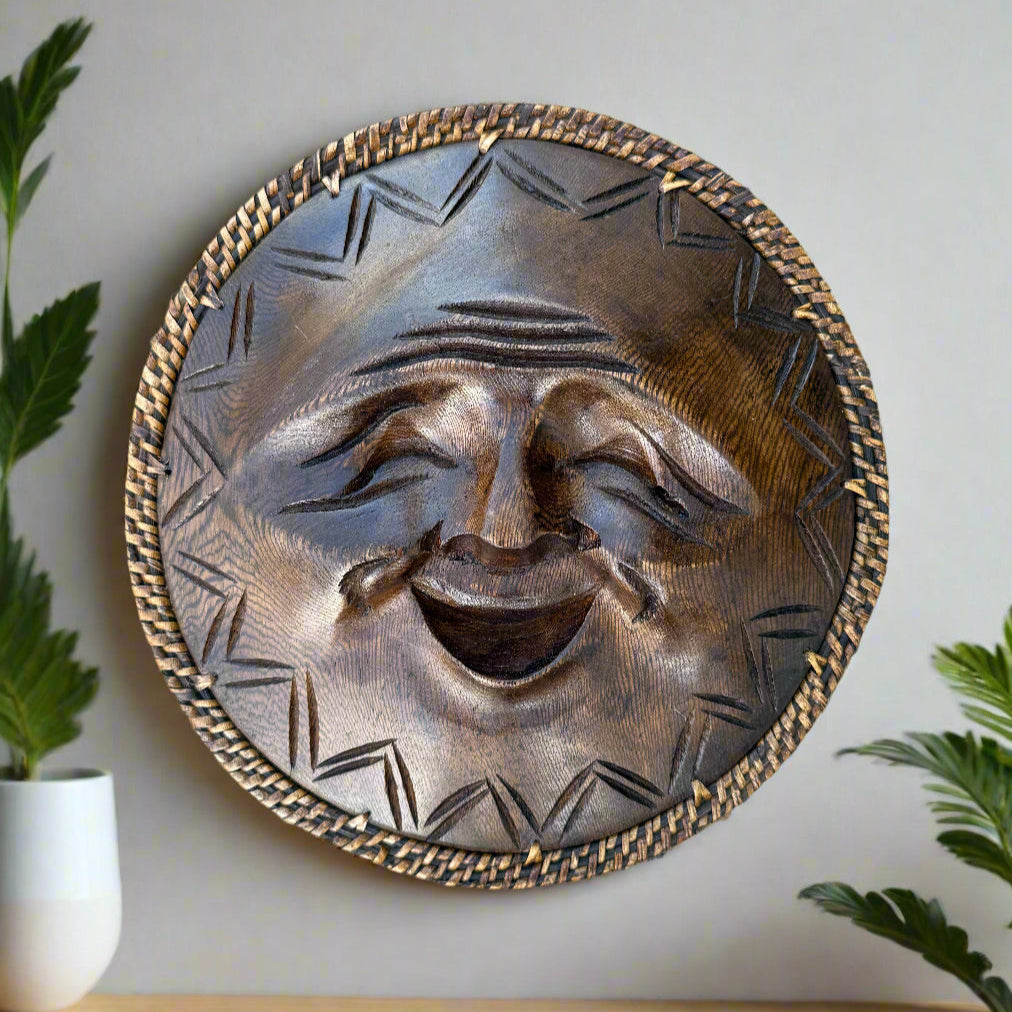 Round metal sun-face wall decoration with a woven border and joyful expression.