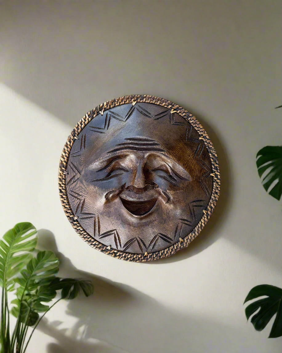 Round sun face wall sculpture with woven border and geometric pattern