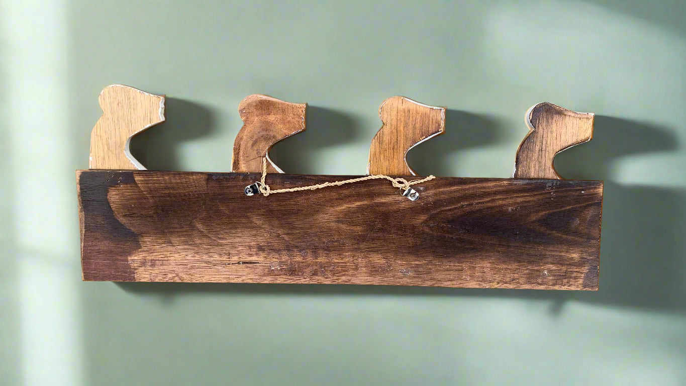 Rustic wooden wall-mounted rack with four horse-head hooks