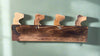 Rustic wooden wall-mounted rack with four horse-head hooks