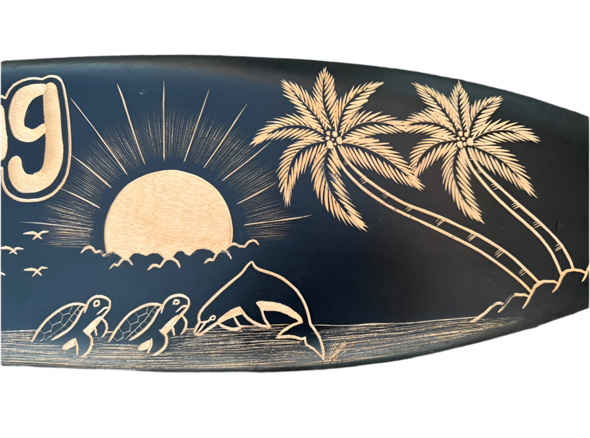 Sunset scene with palm trees and sea turtles carved on a surfboard