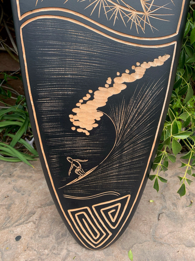 Copper-etched surfboard wall art showing a surfer riding a wave with geometric accents.