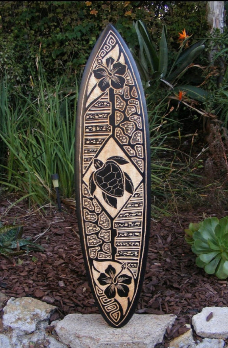 Hawaiian carved surfboard with hibiscus flowers and sea turtle design