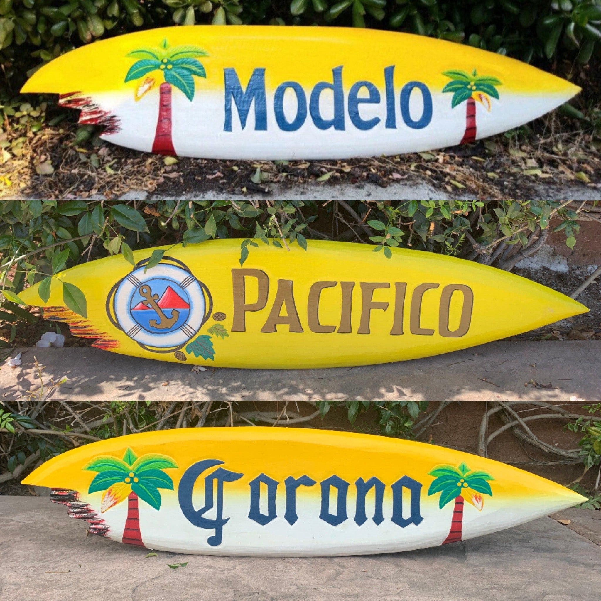 Bright yellow surfboards painted with Modelo, Pacifico, and Corona logos and palm trees