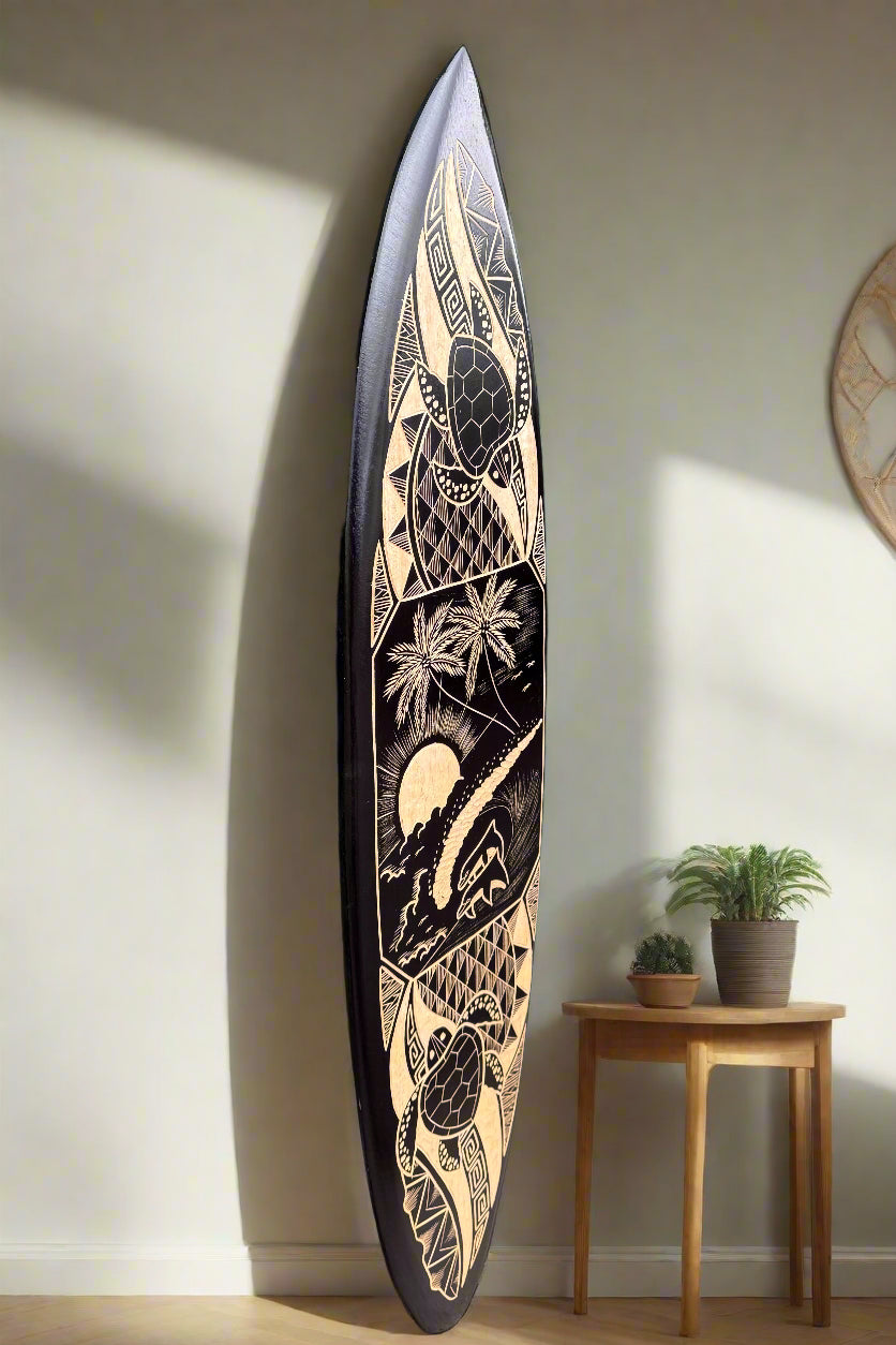 Tall tribal-patterned surfboard leaning against a wall in a cozy living space
