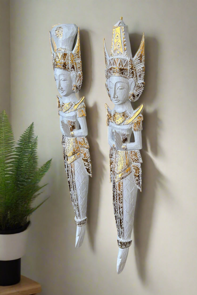 Pair of white and gold Thai wall-mounted statues with tall crowns and prayer hands