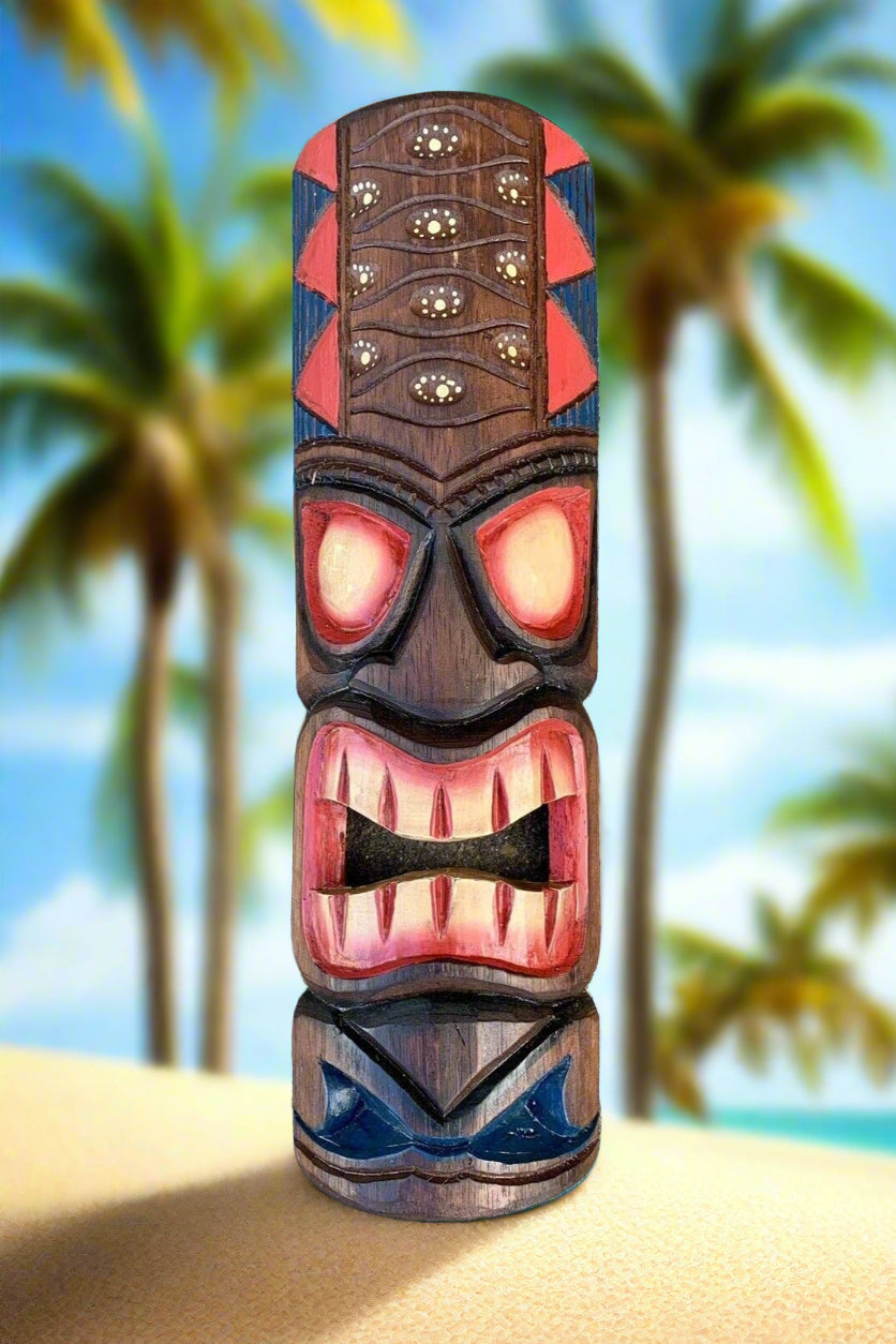 Carved tiki totem on tropical beach with palm trees in background