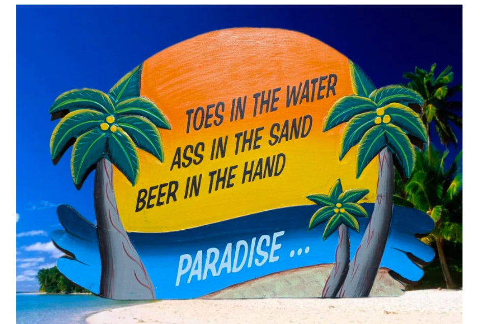 Tropical beach sign with palm trees and the word Paradise on a sunny day
