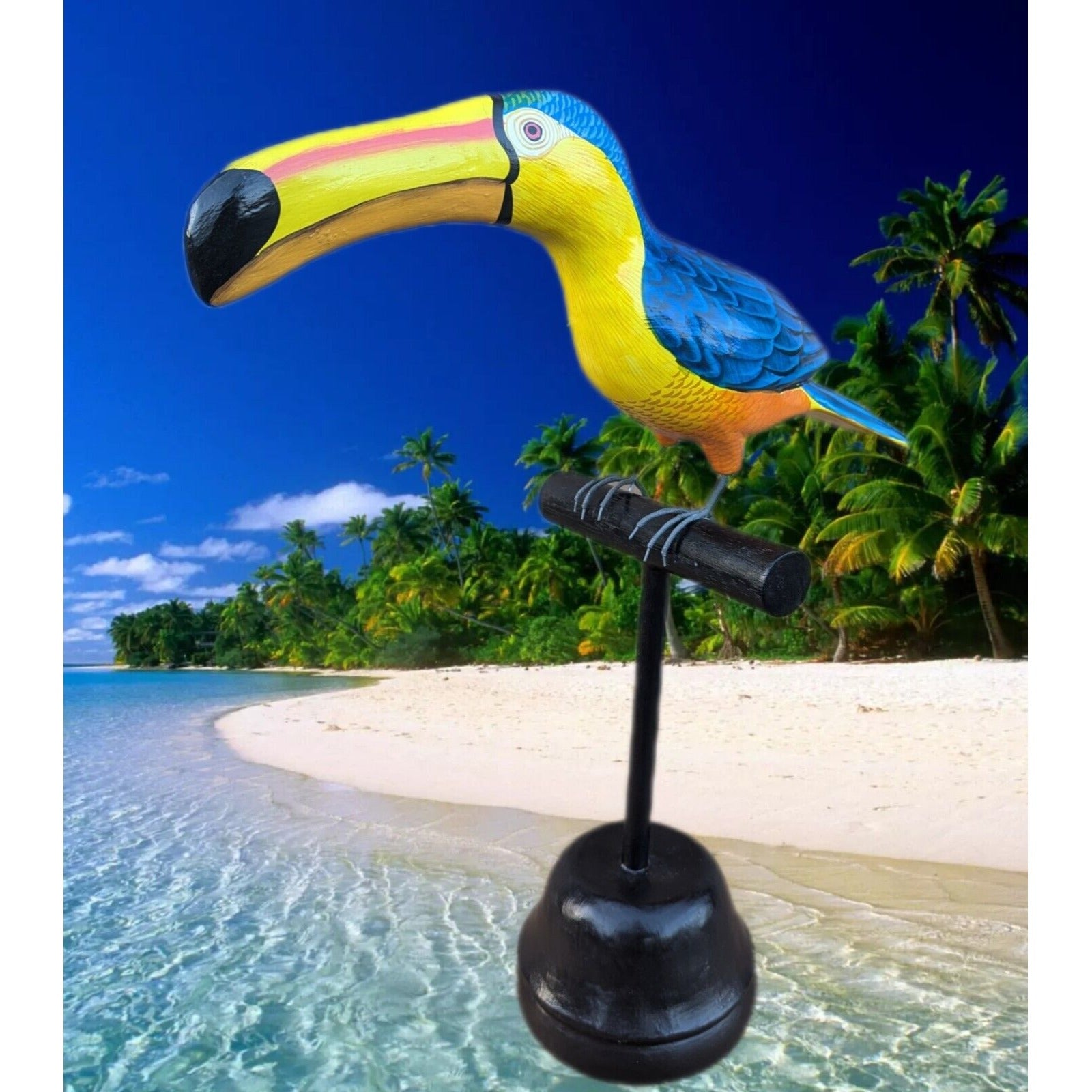 colorful toucan tiki statue on a stand at a tropical beach with palm trees