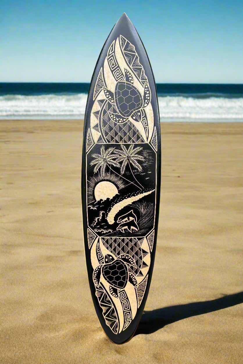 tribal-patterned surfboard on the beach with palm trees and sunset