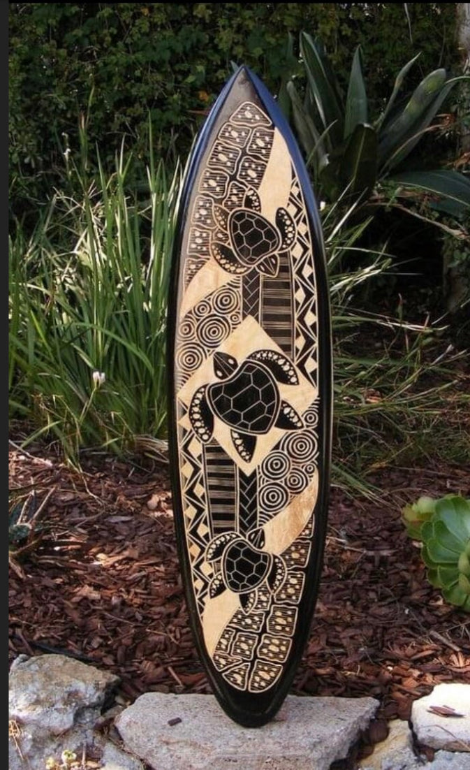 Hand-painted tribal turtle surfboard with black and cream geometric patterns