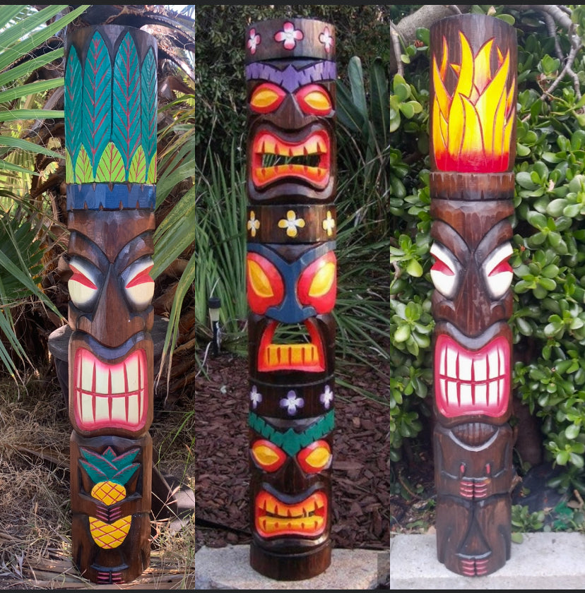 Triptych of colorful tiki totem poles with bold faces and tropical patterns in a garden