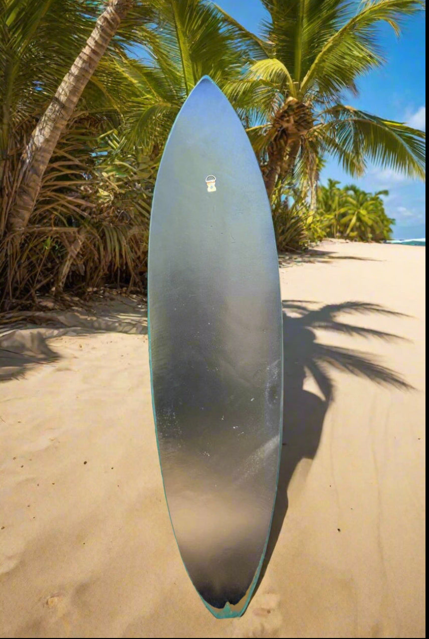 Surfboard standing upright on a sunny tropical beach with palm trees and blue sky