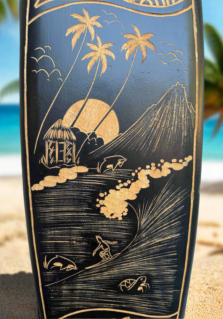 Carved wooden beach scene with palm trees, a hut, sun, waves and a mountain.
