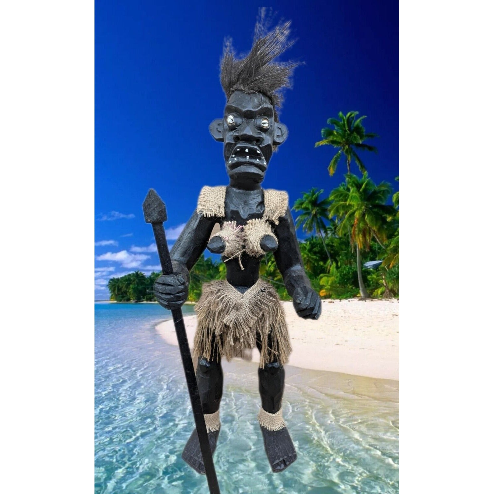 Black tiki warrior figurine with burlap clothing on tropical beach holding a spear