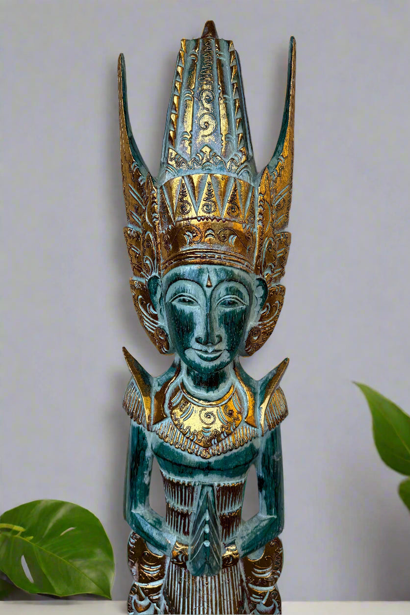 Turquoise and gold carved deity statue with a tall ornate headdress