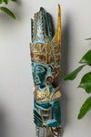 Turquoise and gold ornate tribal statue with tall headdress