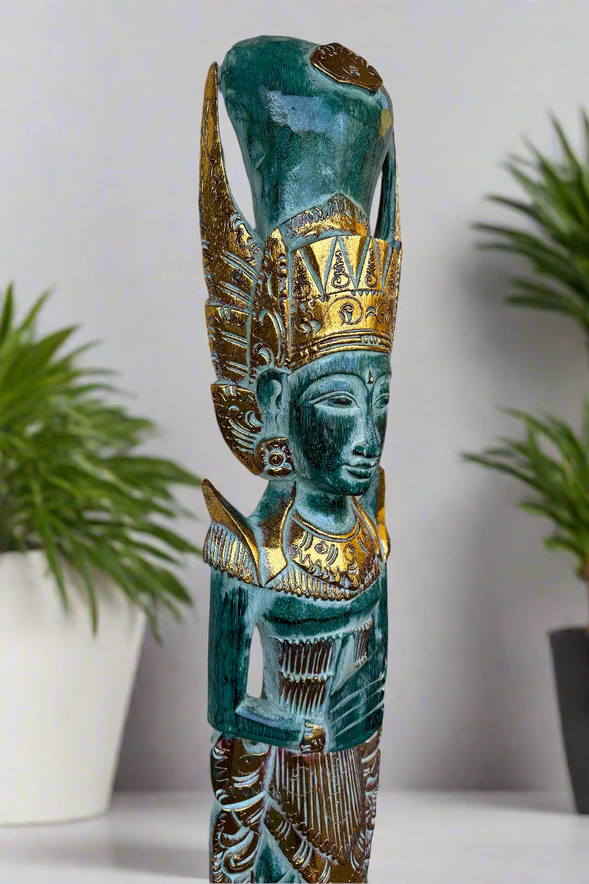 Turquoise carved statue with gold crown and intricate detailing.