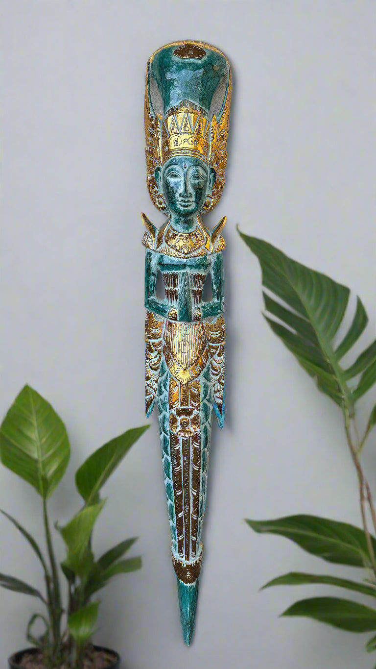 Turquoise and gold carved ceremonial tiki statue with ornate headdress.