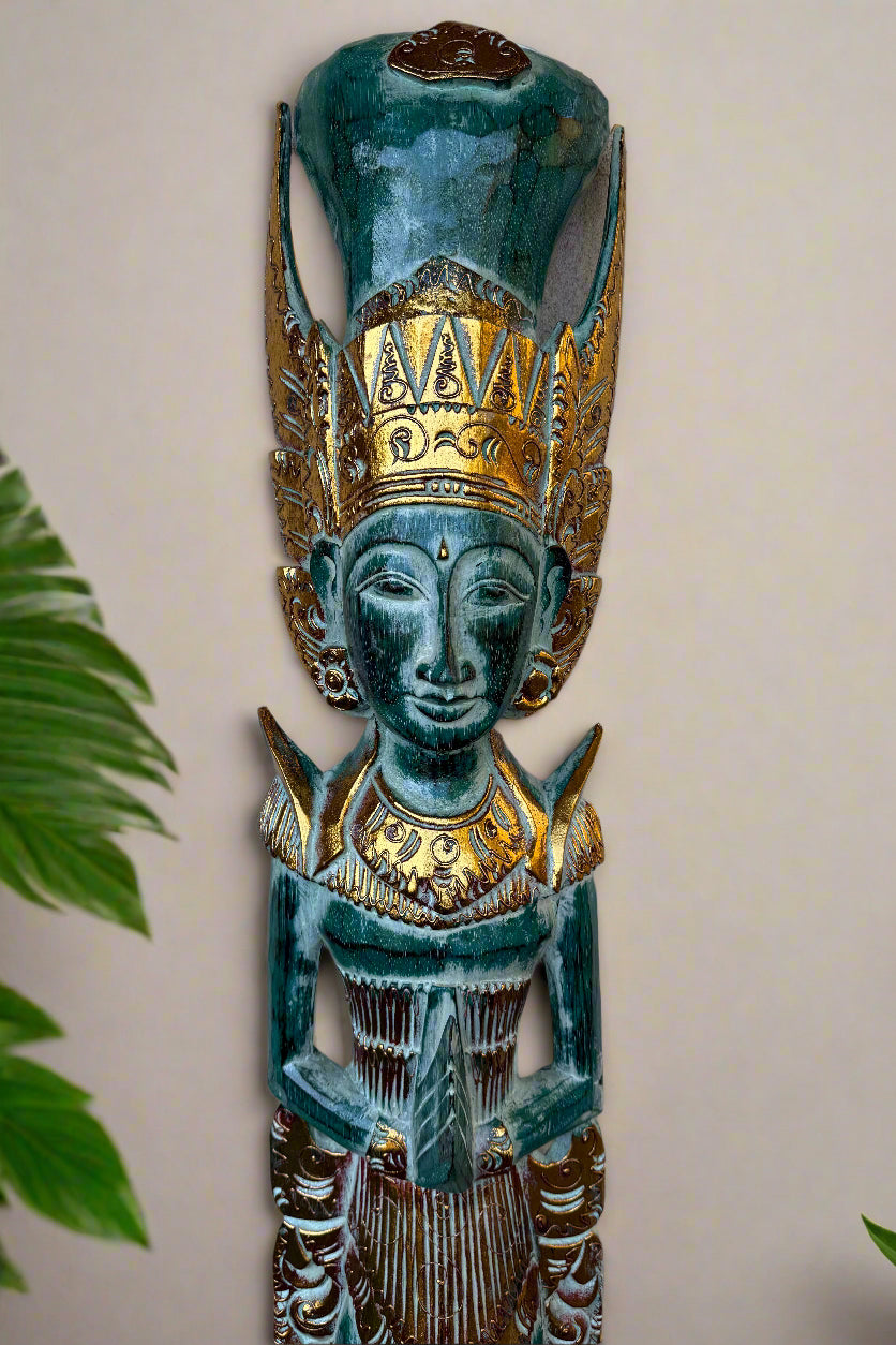 Turquoise carved wooden statue with a gilded crown and ornate gold detailing.