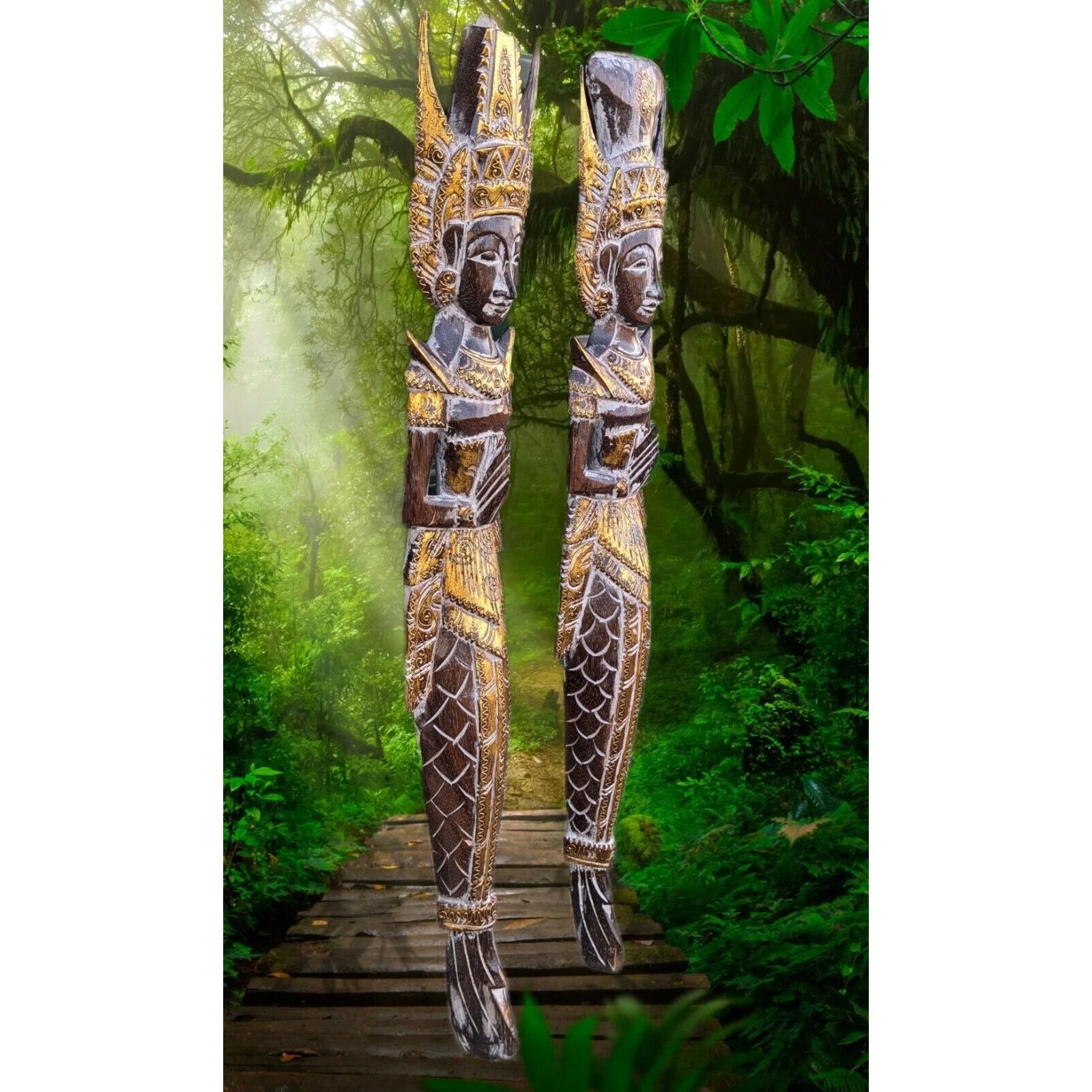Two ornate wooden totem statues with carved details stand on a wooden path in a lush jungle.