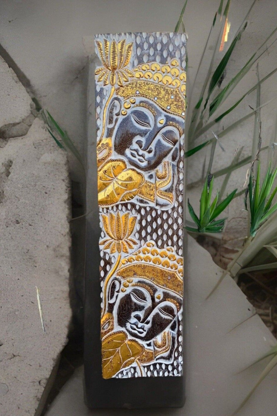 Vertical panel with golden Buddha reliefs and lotus flower accents