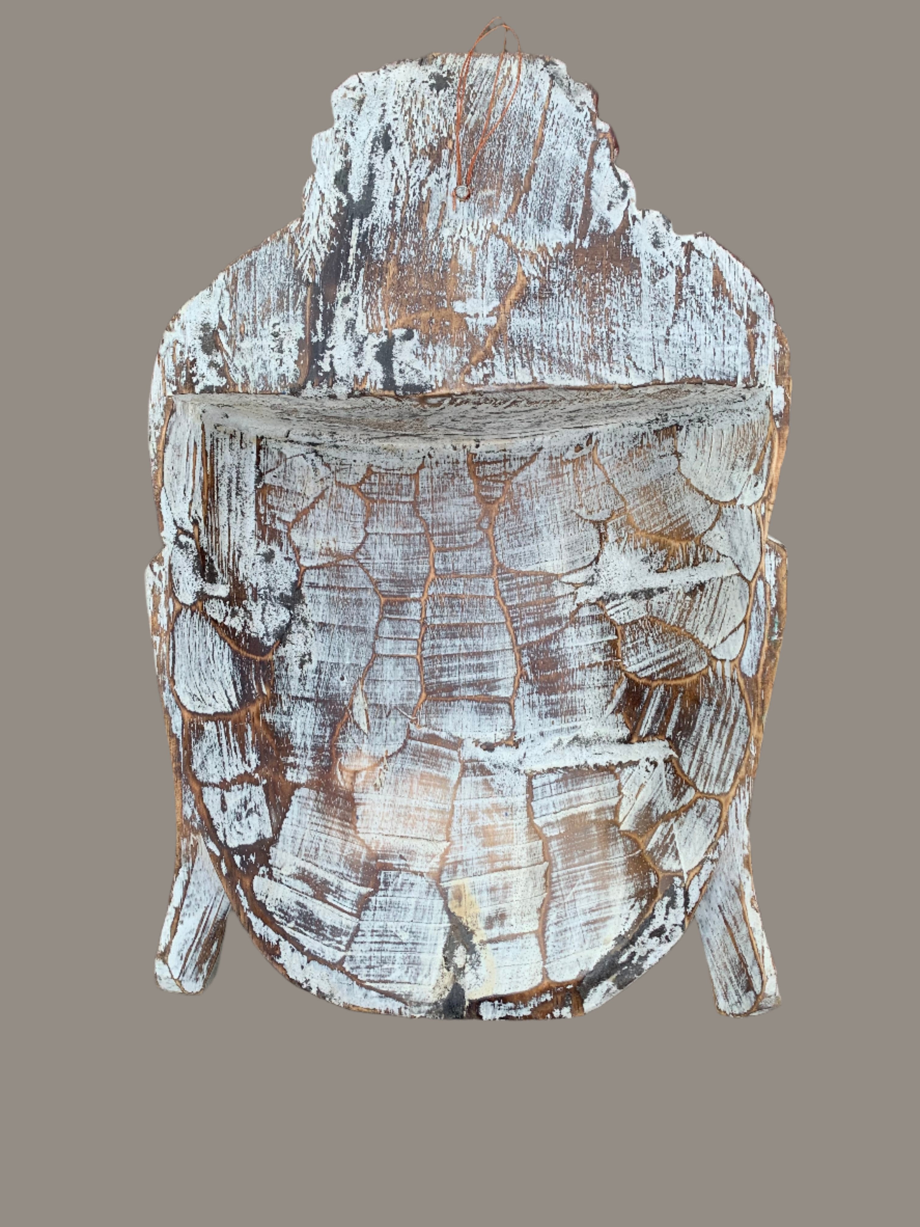 Rustic wooden turtle carving with cracked white paint and a hanging loop