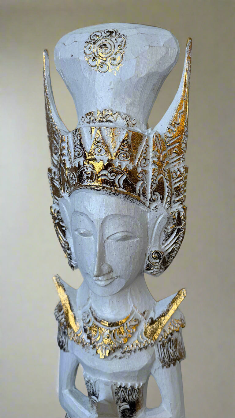 White carved statue with an ornate gilded crown and gold detailing