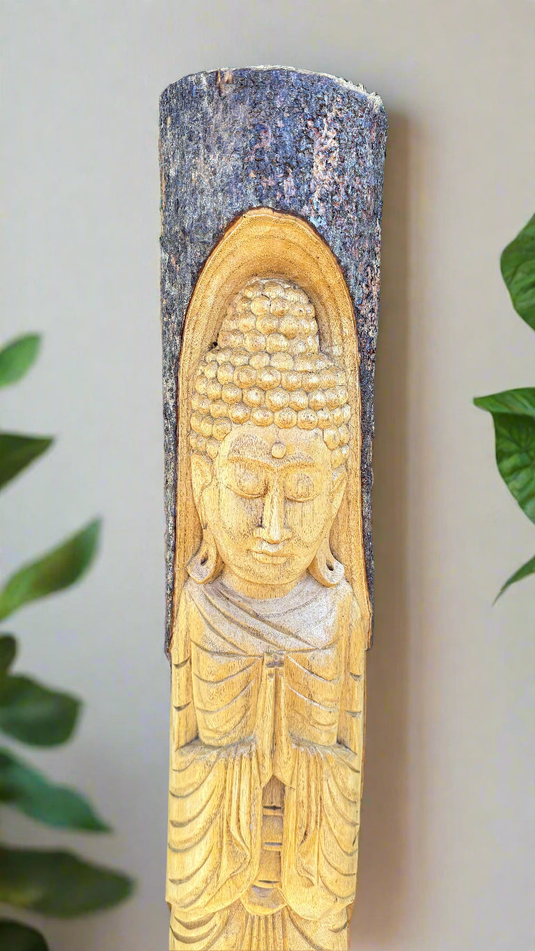 Wooden Buddha statue carved into a tree trunk post