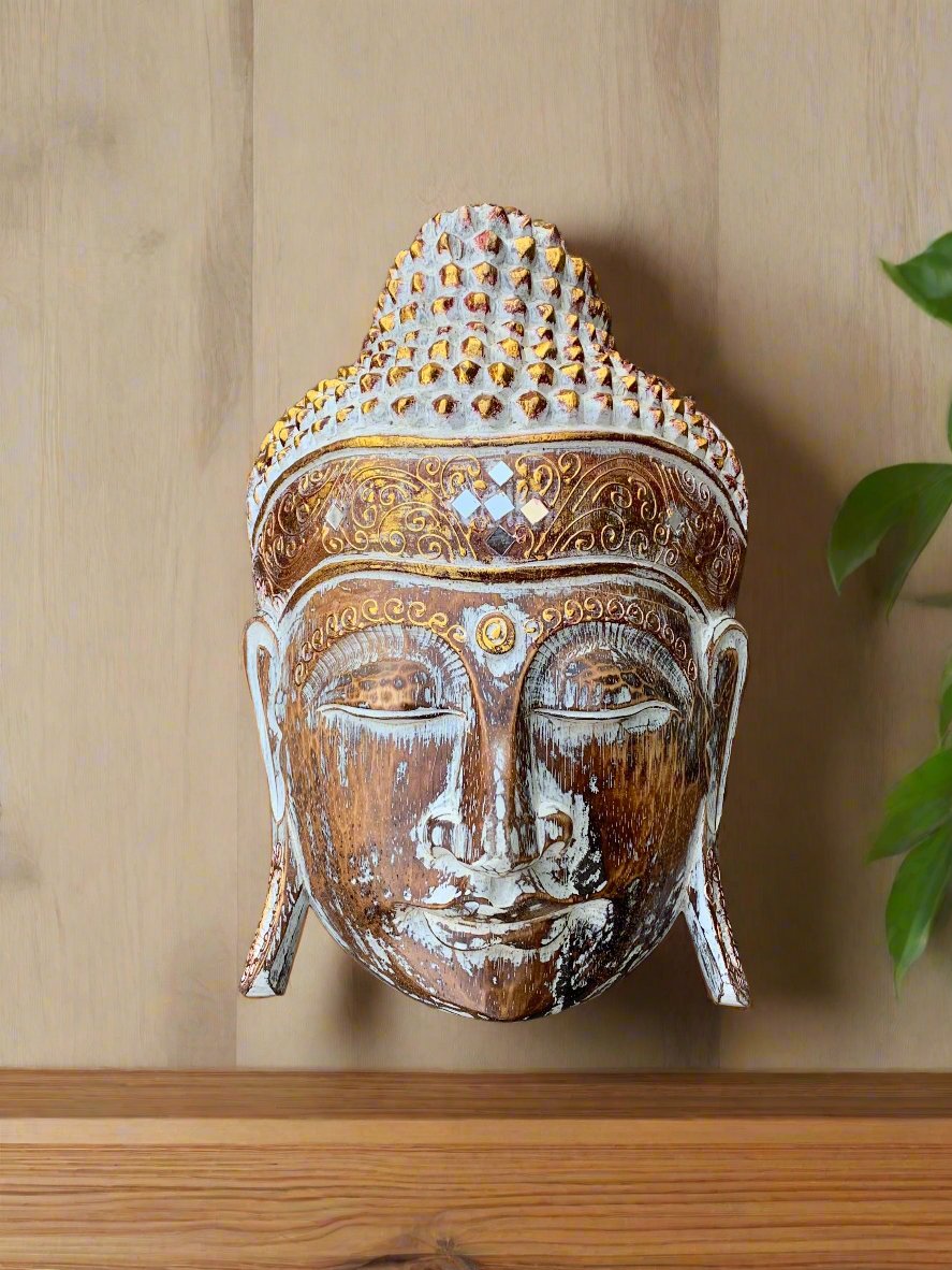 Wooden Buddha head statue with ornate gold carvings and distressed finish