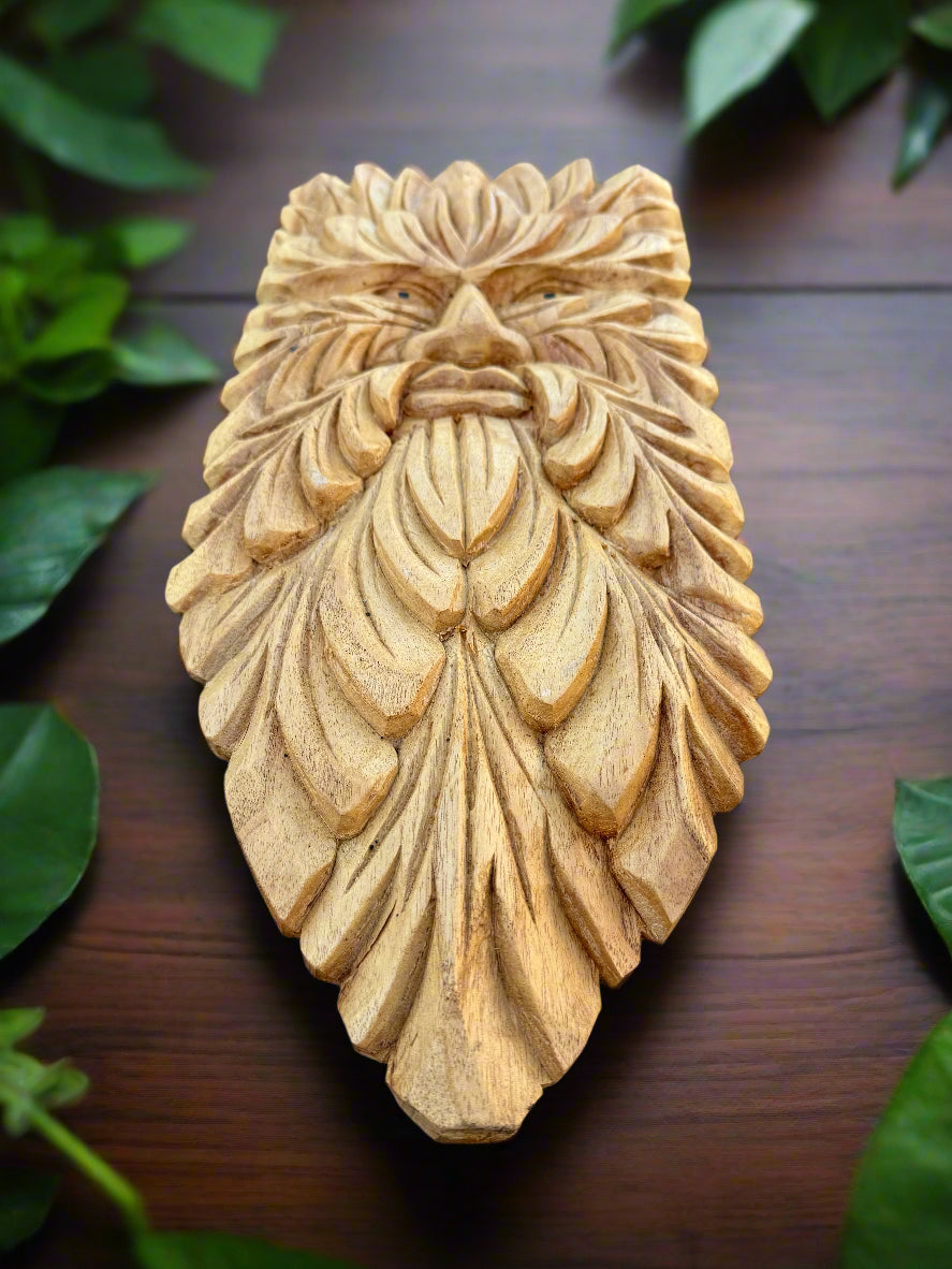 Wooden carved bearded face sculpture with leaf-like pattern