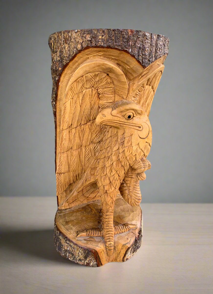 Carved wooden bird perched on a tree trunk